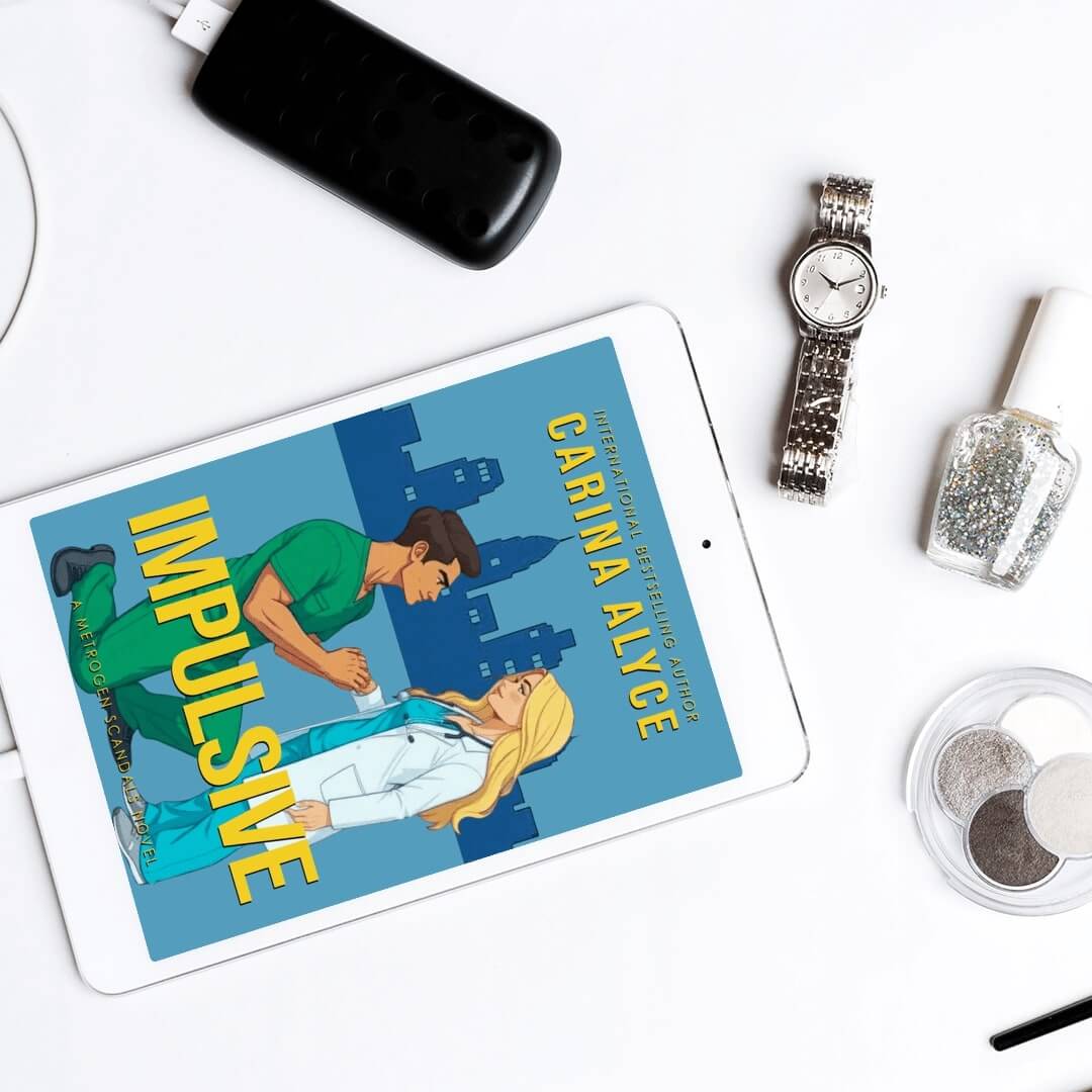 Tablet displaying the book cover of 'Impulsive' by Carina Alyce on a white surface with a watch and other items.
