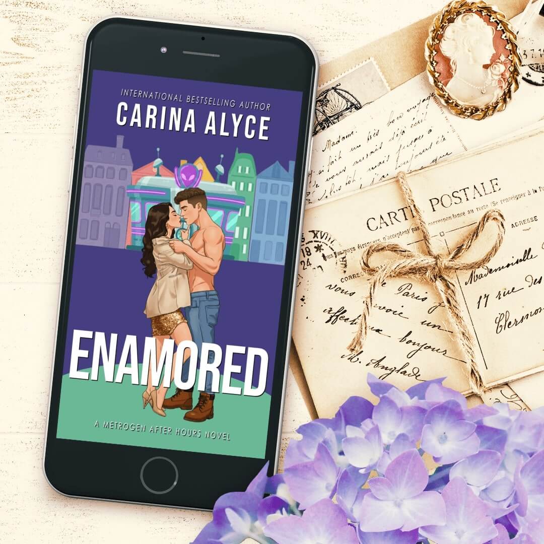 Phone displaying 'Enamored' book cover by Carina Alyce on a decorative background with letters and flowers.