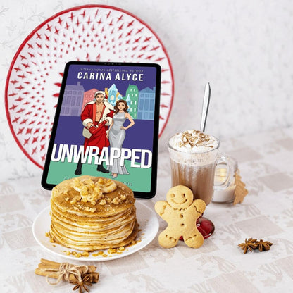 Tablet displaying 'Unwrapped' by Carina Alyce with pancakes and hot chocolate on a table.