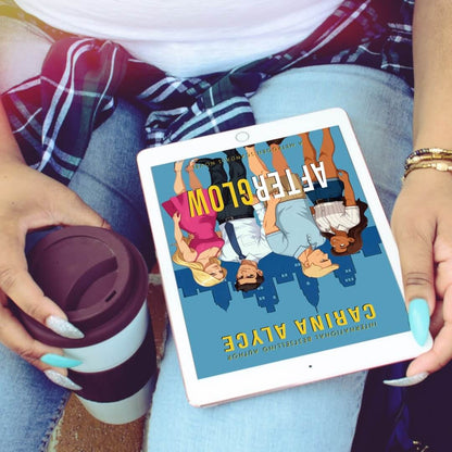 Person holding a tablet with a book cover displayed, wearing a plaid shirt and holding a coffee cup.