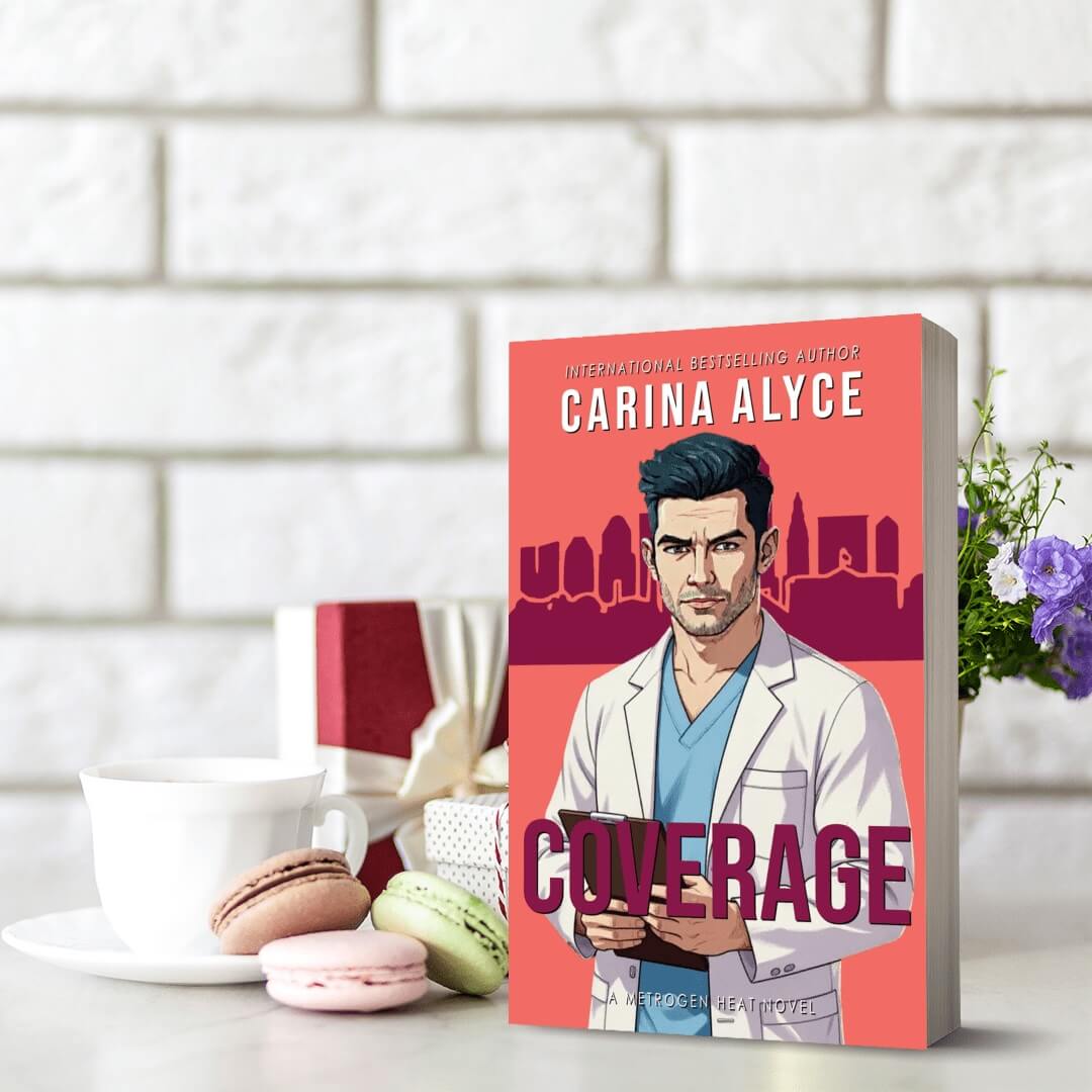 Book titled 'Coverage' by Carina Alyce on a table with macarons and a cup of coffee.