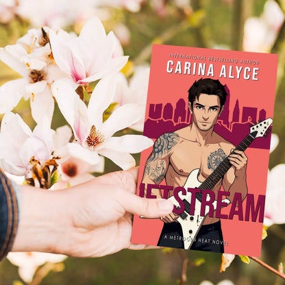 Book titled 'jeTStream' by Carina Alyce held in front of a floral background