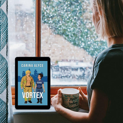 Person holding a mug and a tablet with a book cover displayed on it, looking out a window on a rainy day.